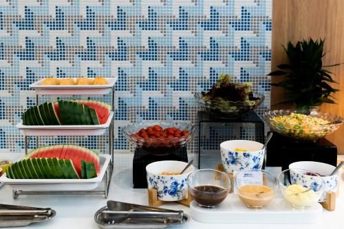 a buffet with bowls of fruit and other food at Holiday Inn Express Shanghai Tangzhen by IHG - 20 mins to PVG Airport and Disney land in Shanghai