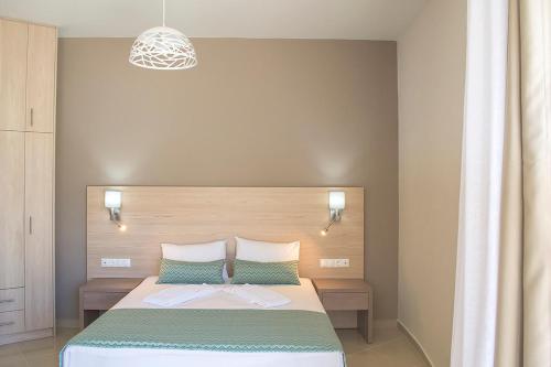 a bedroom with a large bed and a light at Giorgos and Maria in Plakias