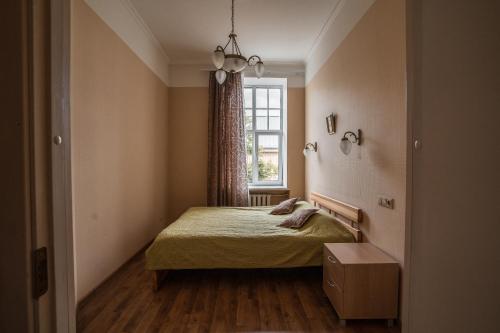 a small bedroom with a bed and a window at Lāčplēša Central Apartments in Riga