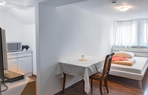 ハノーファーにあるRestaurant Trocaderoのテーブルと窓が備わる小さな白い客室です。