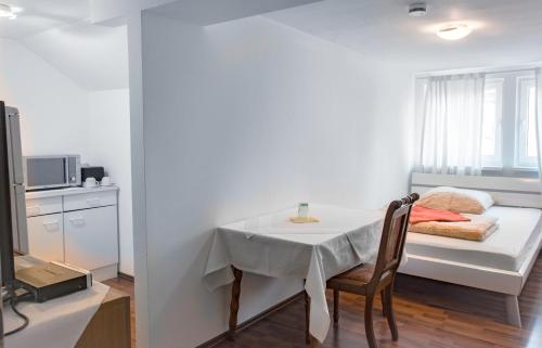 a small white room with a table and a window at Restaurant Trocadero in Hannover