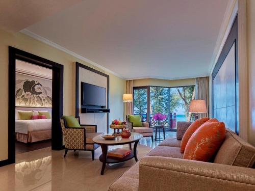 
a living room filled with furniture and a tv at Dusit Thani Laguna Phuket - SHA Extra Plus in Bang Tao Beach
