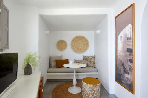 a living room with a couch and a table at Filotera Suites in Oia