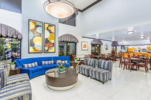 a lobby with a blue couch and chairs and tables at Holiday Inn Express San Diego - Sea World Area by IHG in San Diego