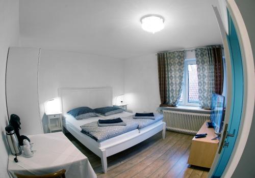 a bedroom with a bed and a mirror at Restaurant Trocadero in Hannover