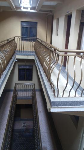 an empty staircase in a building with brown seats at Highway Motel in Nebbi