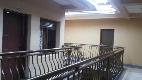 an empty room with a balcony with two doors at Highway Motel in Nebbi