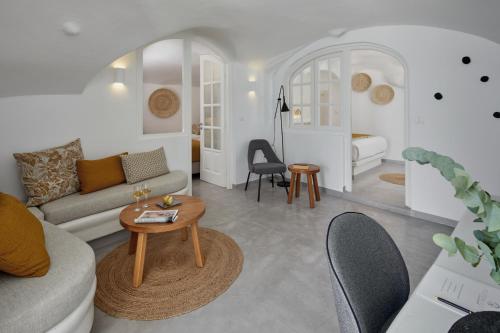 a living room with a couch and a table at Filotera Suites in Oia