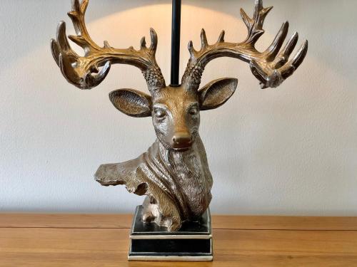 a bronze trophy of a deer with antlers on a table at Bodarfor in Trearddur