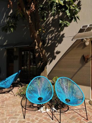 three blue chairs sitting in front of a building at Ikamu's lodge in Germiston