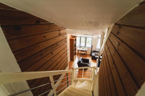 an overhead view of a staircase in a house with wooden walls at Ô Rethel Jacuzzi, Gîte Ardennes in Rethel