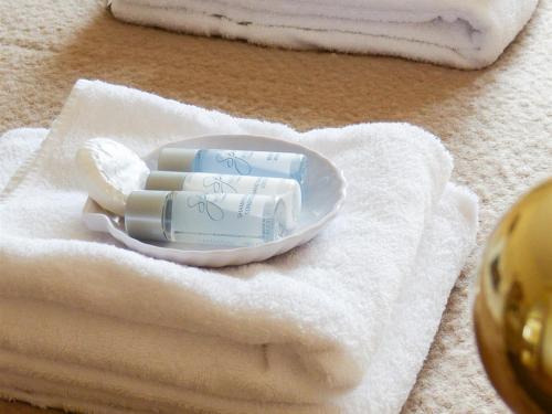 a pile of soap on a plate on a towel at The Green Man Boutique Hotel in Takeley