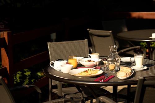 a table with food and drinks on top at Apart Hotel Jablonec in Jablonec nad Nisou