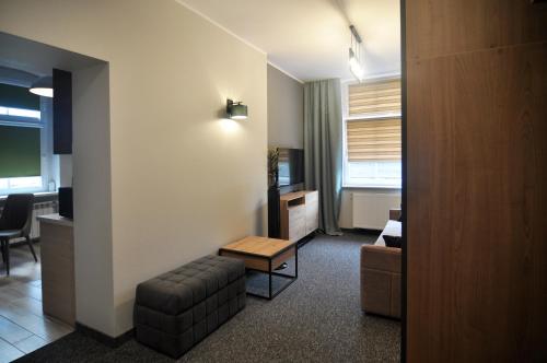 a living room with a couch and a table at Apartamenty Centrum Chodzież in Chodzież