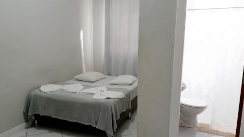 A bed or beds in a room at Hotel Bella Júlia