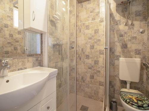 a bathroom with a shower and a sink and a toilet at Comfort Apartment with Sea View in Neum