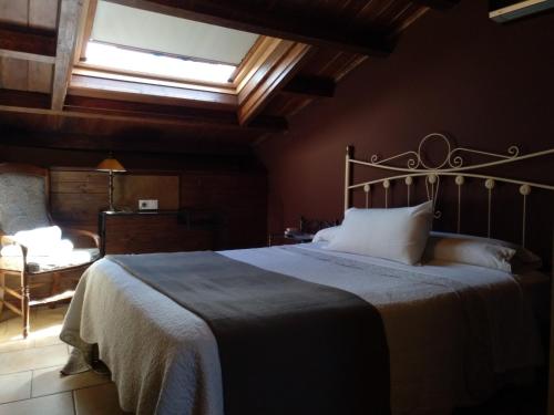 a bedroom with a large bed and a window at Hostal Medievo in Monforte de Lemos