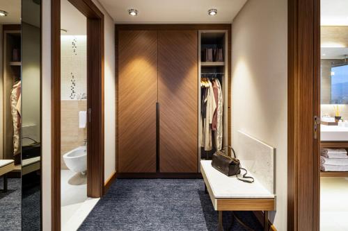 a bathroom with a walk in closet and a toilet at Grand Hotel Millennium Sofia in Sofia