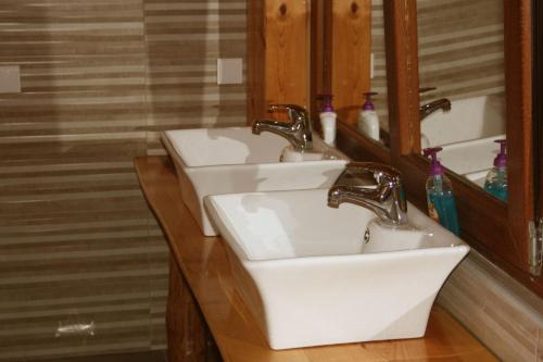 a bathroom with two sinks and a mirror at Tara Place - Camp Rabrenovic in Mojkovac