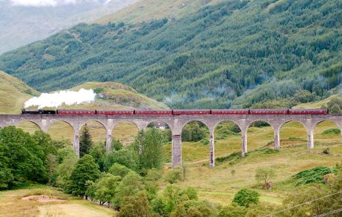 a train on a bridge over a mountain at Alexandra Hotel in Fort William