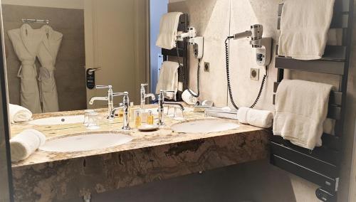 a bathroom with two sinks and a large mirror at Ermitage de l'Oasis & Spa - Cannes Mandelieu in Mandelieu-la-Napoule