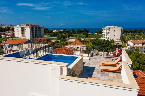 a view from the roof of a house with a swimming pool at De Lux Apartments Luka in Bar
