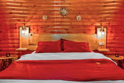 a red bed in a room with wooden walls at Paradise Plus Ağva in Agva