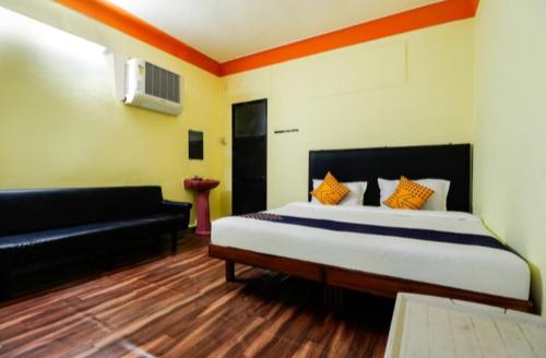 a bedroom with a large bed and a couch at MTDC Meghdhanush park in Igatpuri