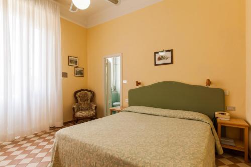 Postel nebo postele na pokoji v ubytování Hotel Britannia