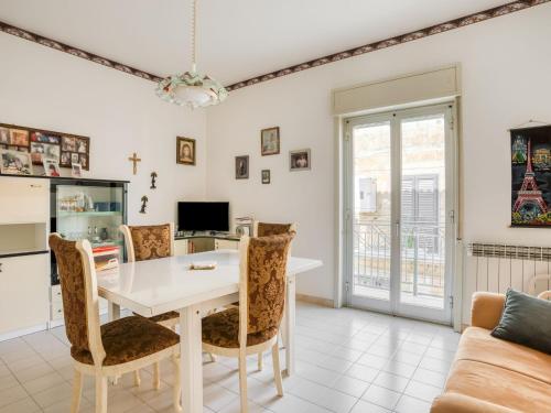 a living room with a white table and chairs at Belvilla by OYO Villa in Santa Caterina Villarmosa in Santa Caterina Villarmosa