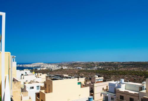 a view of the city from the top of a building at Summer Breeze Apartment with panoramic terrace - by Getawaysmalta in Mellieħa
