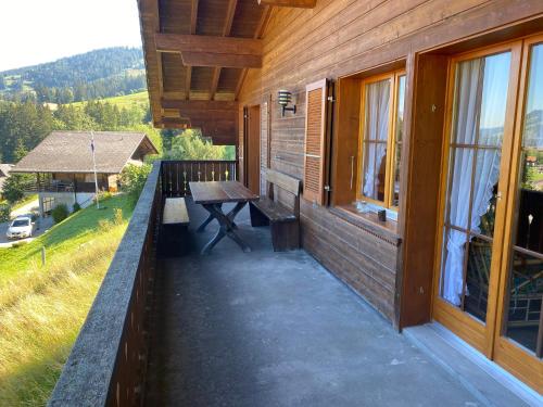 a porch of a house with a picnic table on it at Sorgenfrei in Schwarzsee