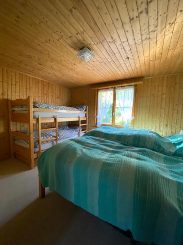 a bedroom with a bed in a wooden cabin at Sorgenfrei in Schwarzsee