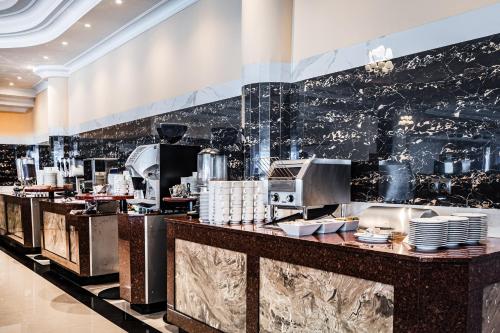 a kitchen with a counter with dishes on it at Hotel Gołębiewski Białystok in Białystok