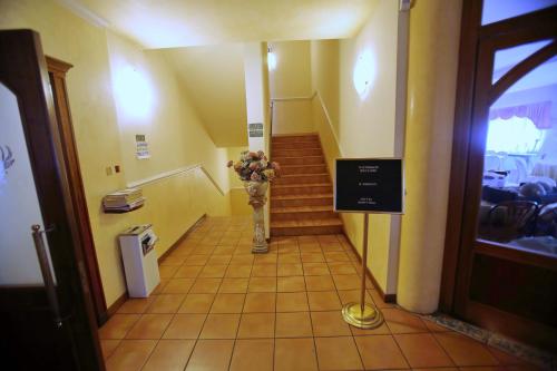 a staircase with a vase of flowers in a hallway at Hotel Sanvitale in Fontanellato