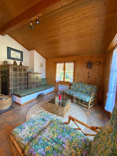 a living room with two beds and a fireplace at Sorgenfrei in Schwarzsee