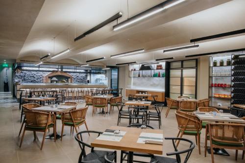a restaurant with tables and chairs and a bar at Napa Plaza Hotel (Adults Only) in Ayia Napa