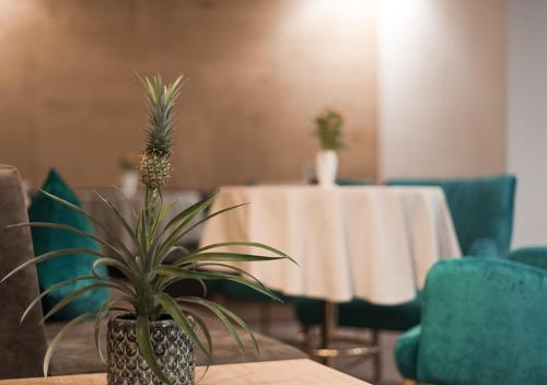 a pineapple plant sitting on a table in a room at Park Hotel Villa Etschland in Plaus