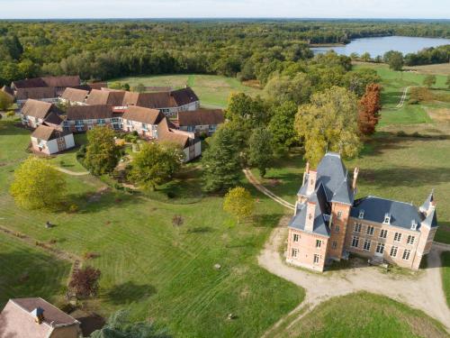 an aerial view of a large house on a field at Domaine de Mont-Evray in Nouan-le-Fuzelier