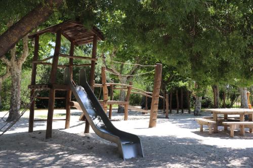 a playground with a slide in a park at Mobil Homes Vacances in Grimaud