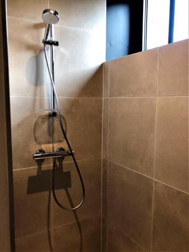 a shower with a shower head in a bathroom at Groot Noordhof in Nieuwpoort