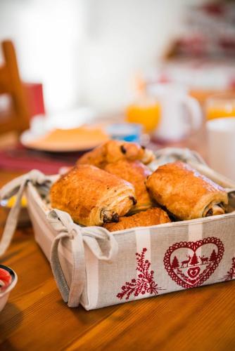 a basket of pastries sitting on a table at Résidence Plein Soleil in Avrieux