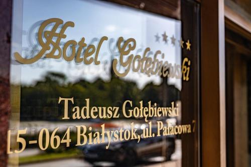 a sign in the window of a store at Hotel Gołębiewski Białystok in Białystok