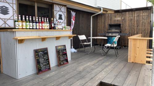 a patio with a bar and a grill with chairs at Riverside Hotel Karatsu Castle in Karatsu