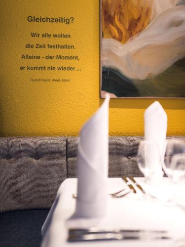 a table with a napkin on top of a table with a picture at Hotel Restaurant Claudia - inklusive SUPER SOMMER CARD in Serfaus