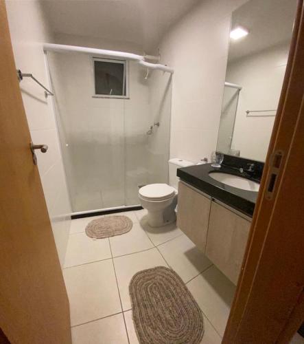 a bathroom with a shower and a toilet and a sink at Arraial do cabo in Arraial do Cabo