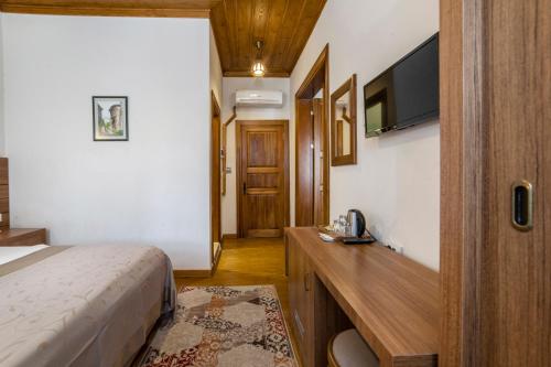 Postel nebo postele na pokoji v ubytování Armistis Hotel