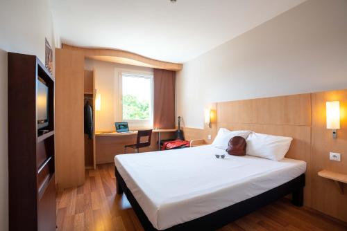 מיטה או מיטות בחדר ב-Ibis Hotel Plzeň