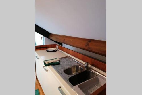 a kitchen with a sink and a counter at Arona 01 attic mansarda secondo piano no ascensore no hotel in Arona