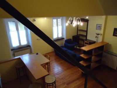 a room with a staircase and a living room at Torres Rojas Attico in Ivrea